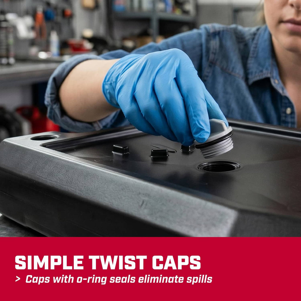 Black oil drain pan with capped openings, shown with gloved hands