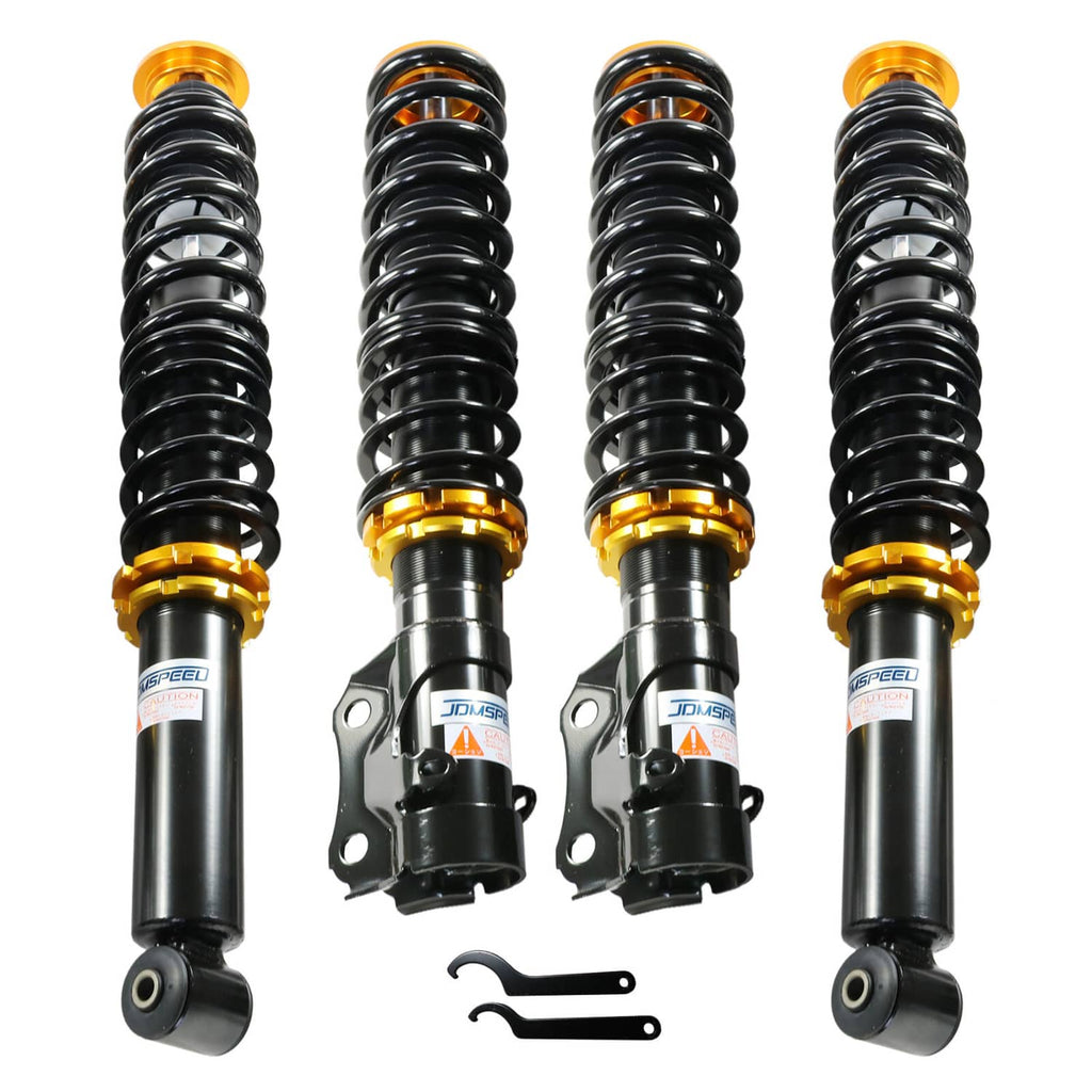 Adjustable coilover suspension struts with black springs and gold threaded collars