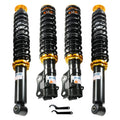 Adjustable coilover suspension struts with black springs and gold threaded collars