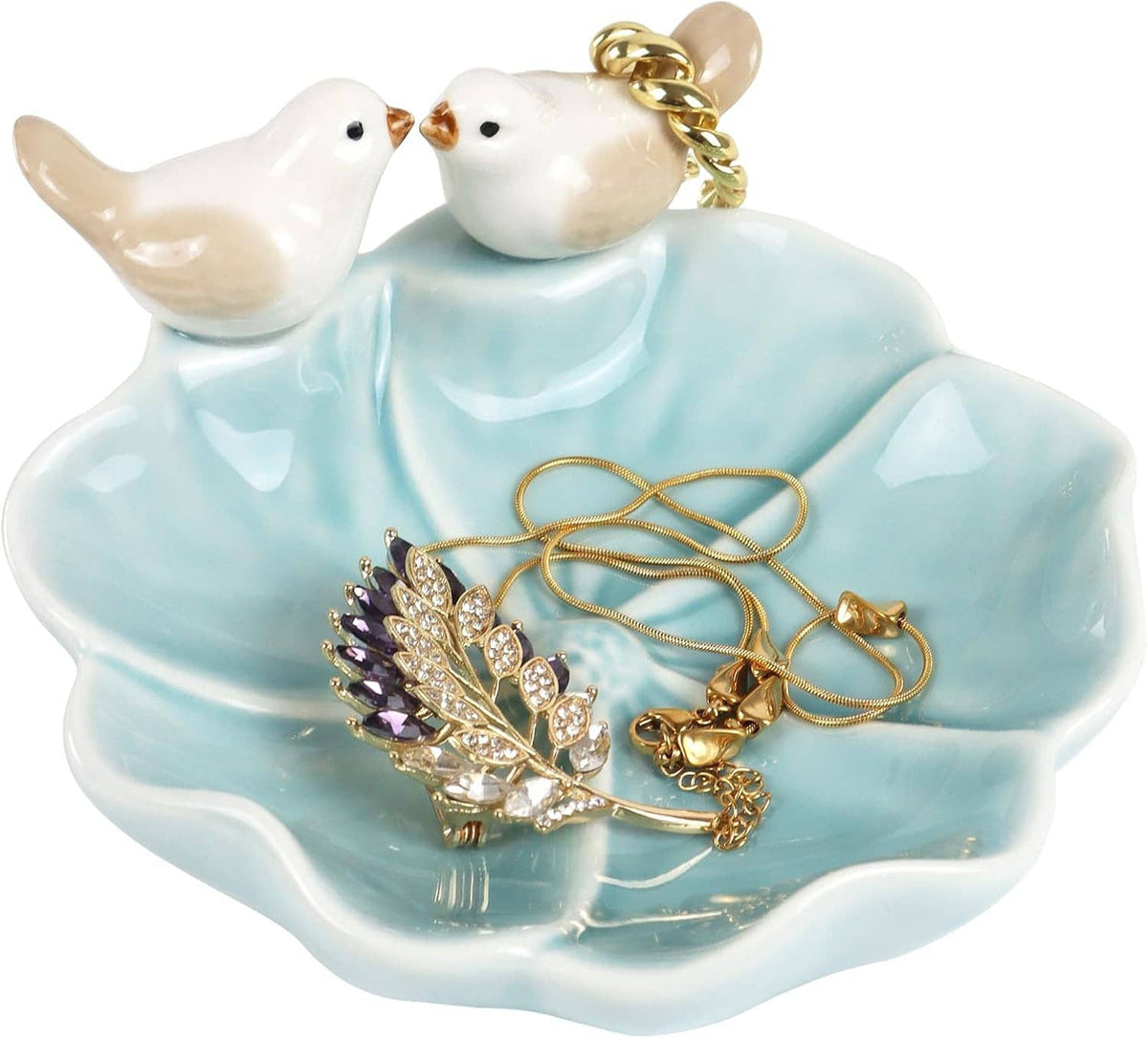 Ceramic ring holder tray with blue lotus leaf design, two white birds, and gold rings