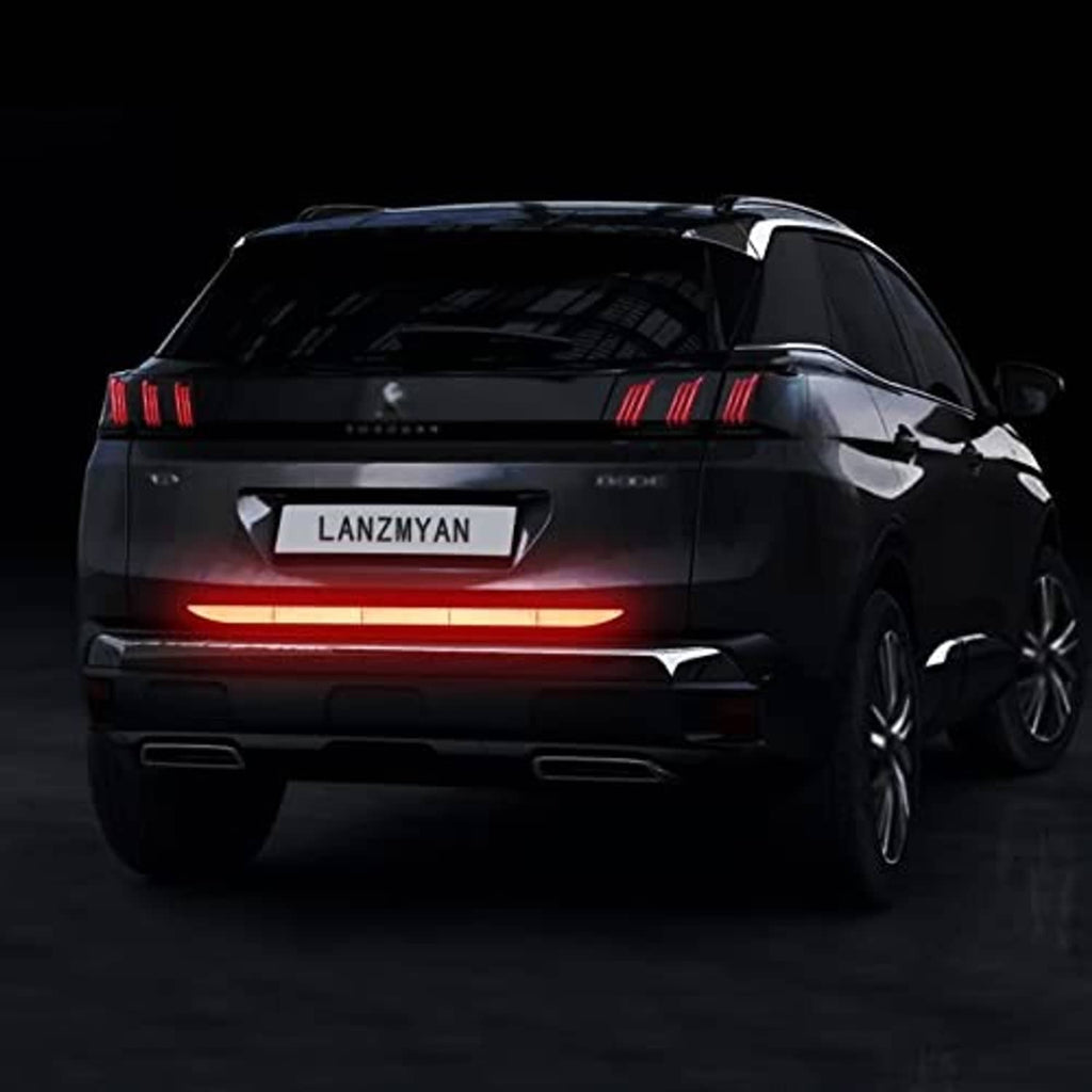 Red reflective bumper guard sticker on rear bumper edge, long horizontal strip