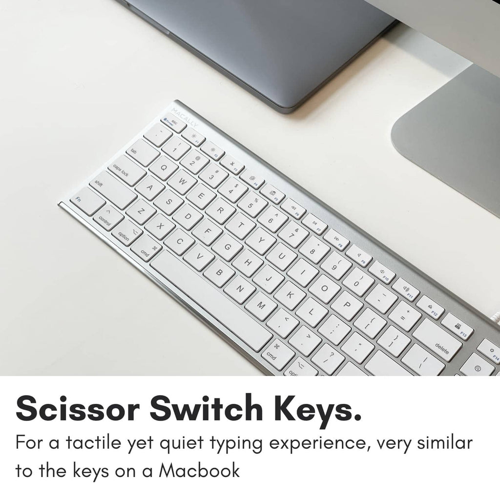 Angled view of slim silver wired keyboard with white keycaps and aluminum frame