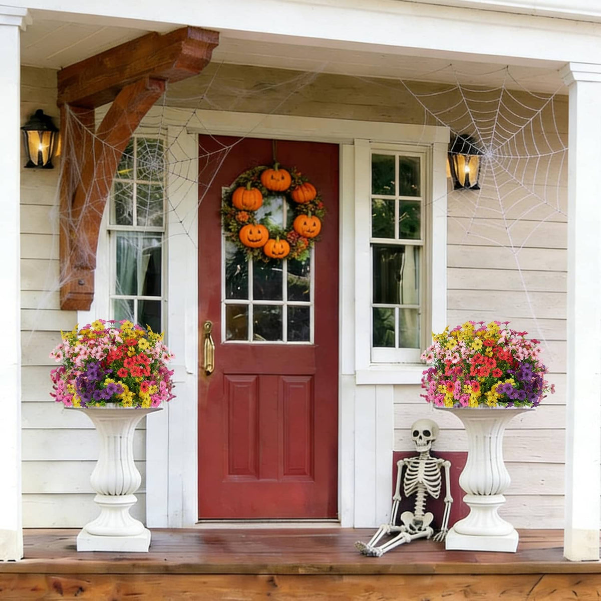 Pair of mixed-color artificial flower arrangements in white pedestal planters