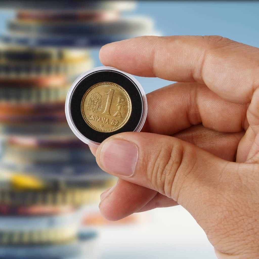Hand holding a coin in a clear protective capsule holder