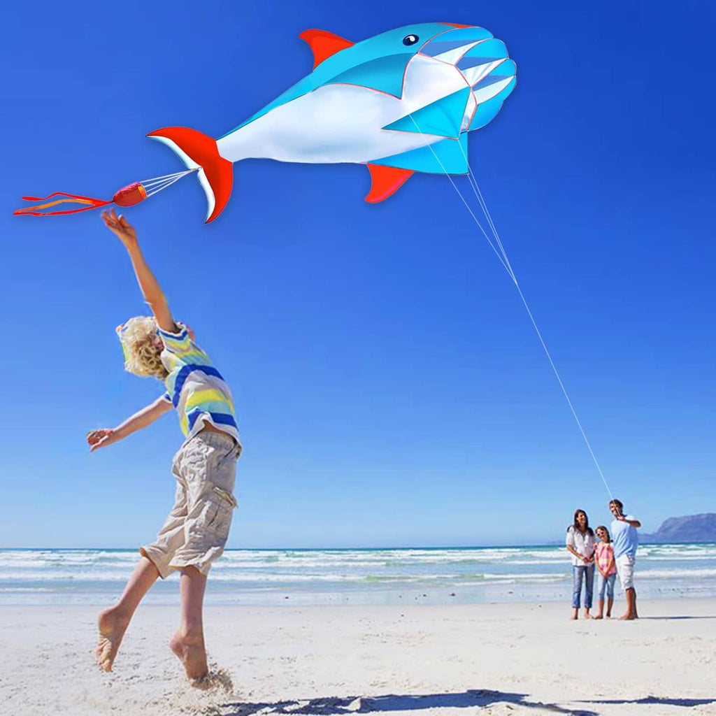 Blue 3D dolphin kite with red fins and white body, diamond-pattern sail with string
