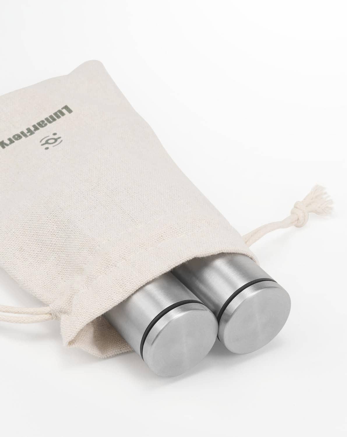 Drawstring storage pouch with stainless steel mini salt and pepper grinders laid on side