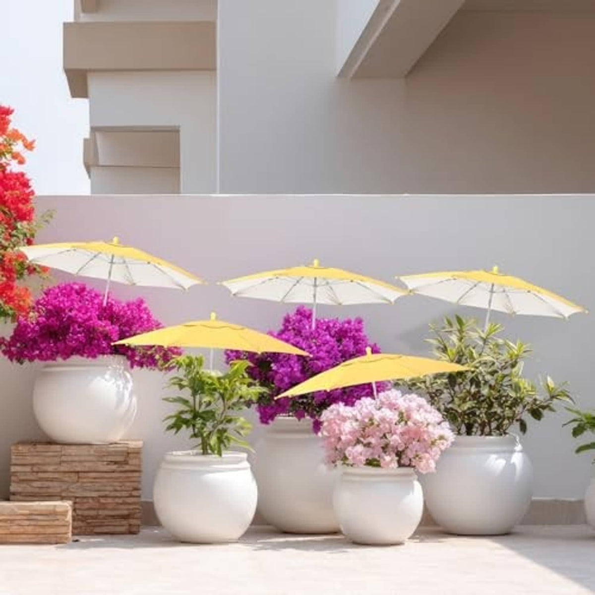 Yellow plant shade umbrellas clustered beside patio planters with blooming flowers