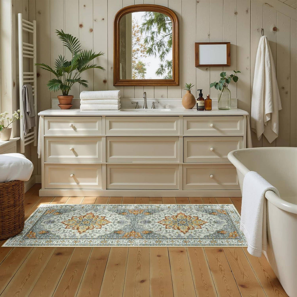 Rectangular low-pile washable area rug with light blue floral border and orange accents