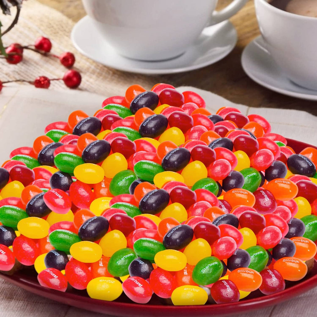 Plate piled with assorted colorful jelly beans in red, green, yellow, orange, and black