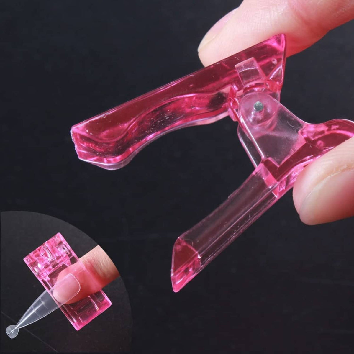 Pink nail tips clip being attached to a fingernail by a hand