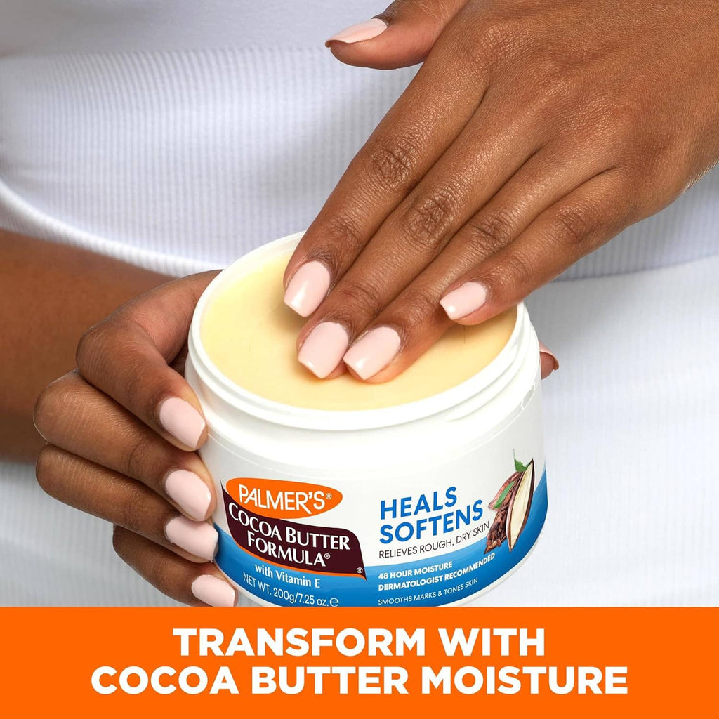 Hands holding PALMER'S Cocoa Butter Formula lotion jar and smoothing cream