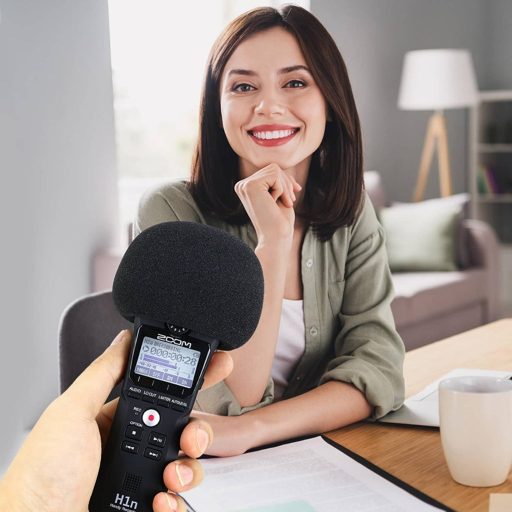 Black foam windscreen held against a handheld recorder for indoor recording