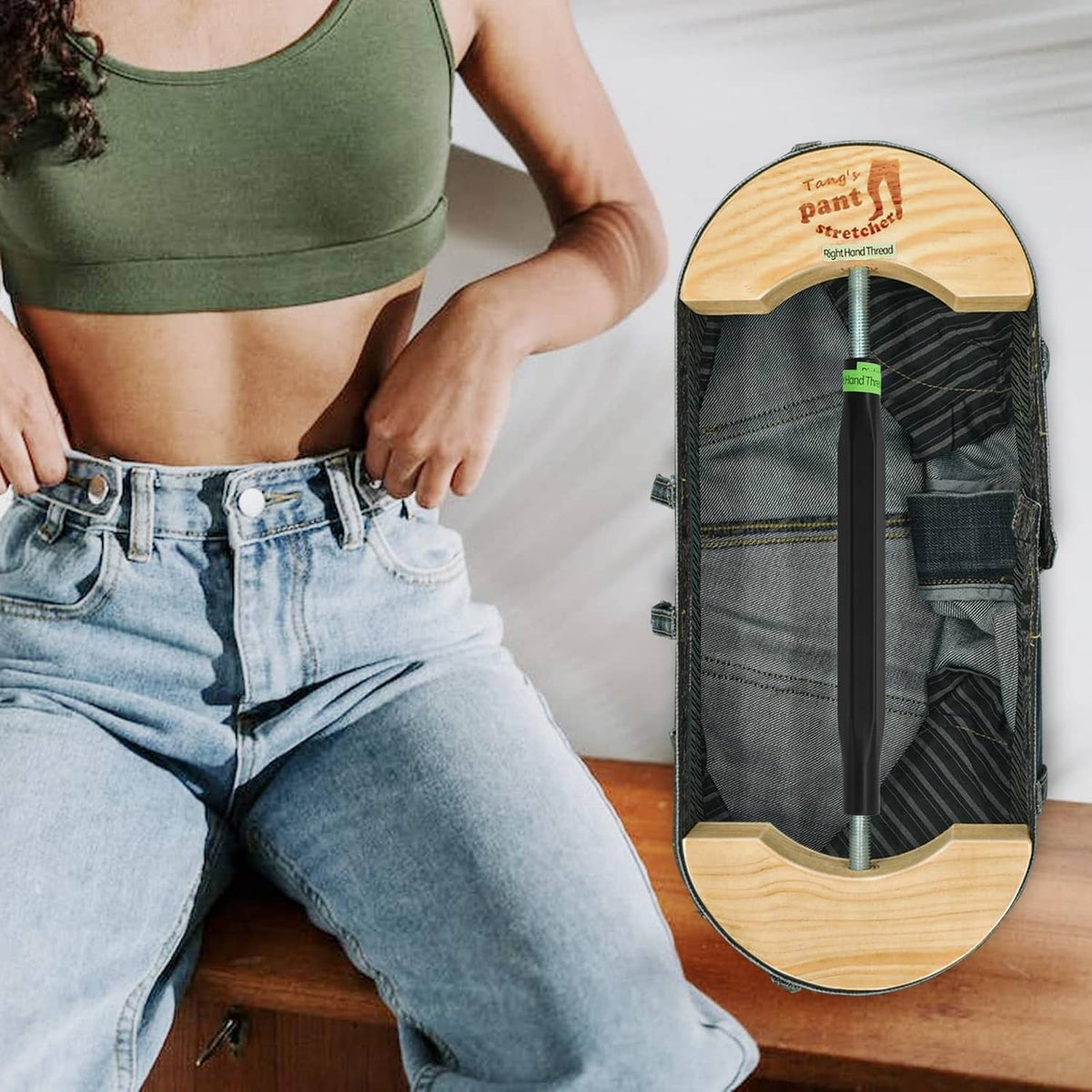 Pant waist stretcher used inside blue jeans waistband, with black rod and wood ends