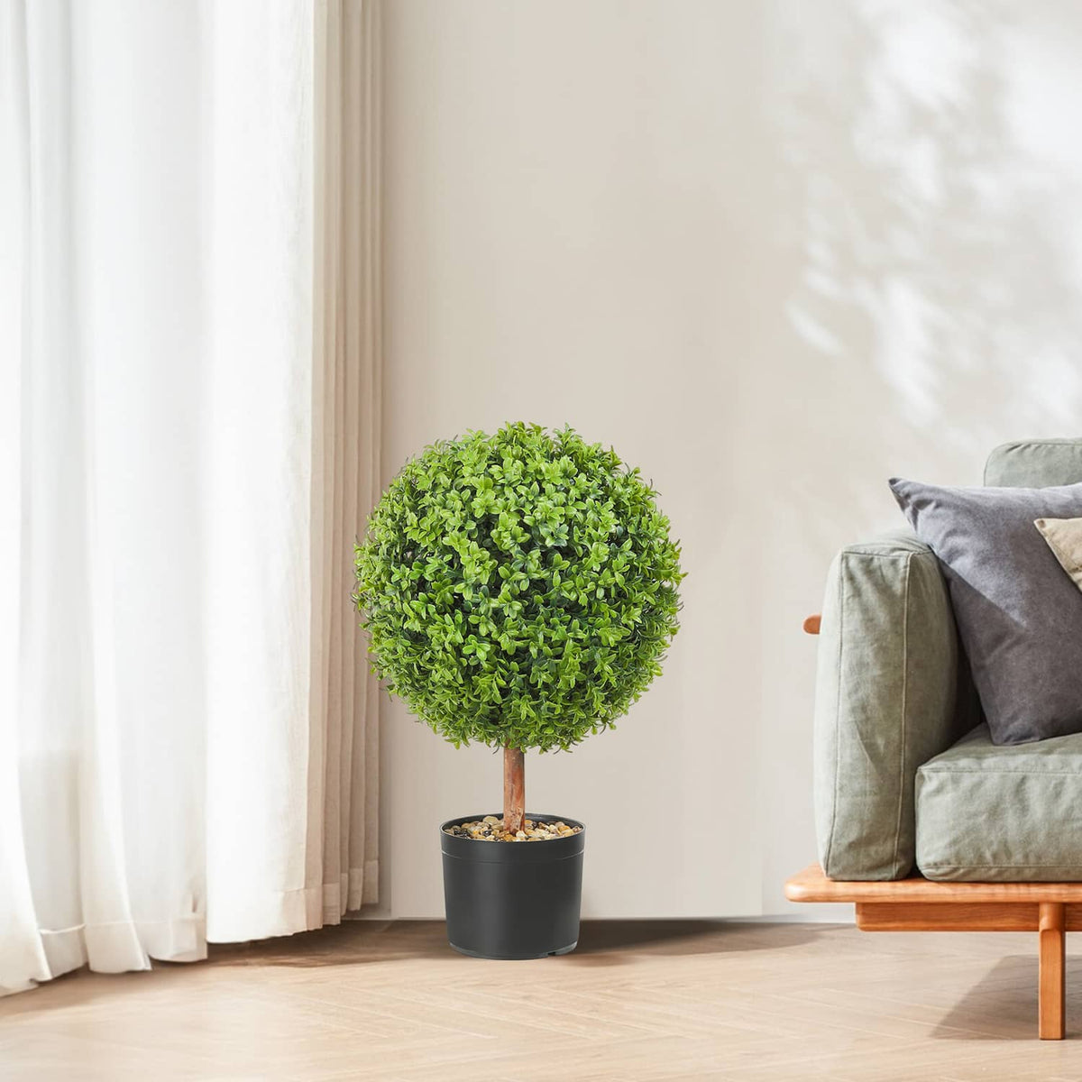 Single artificial topiary tree with bright green round canopy in black pot