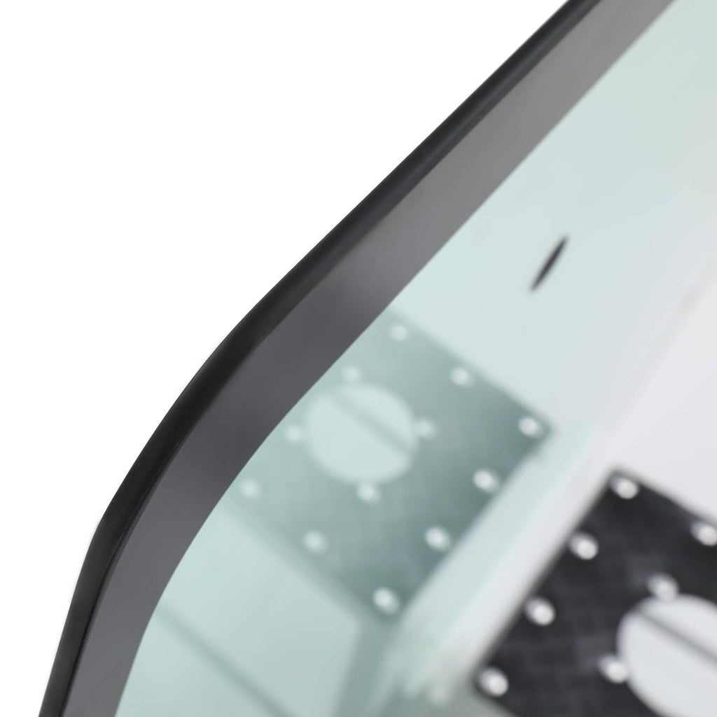 Close-up of window glass edge with black trim and mounting hardware
