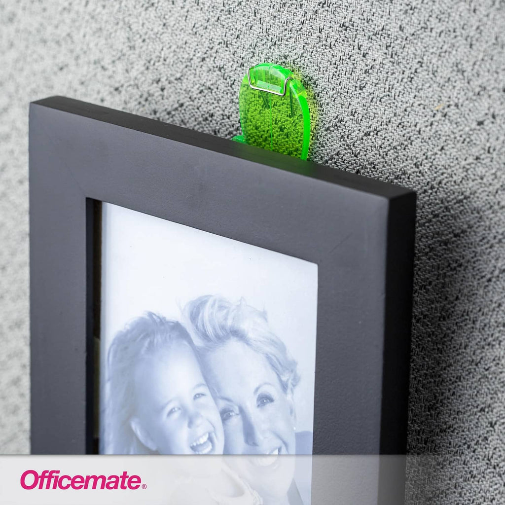 Green translucent office hook holding a photo frame on a board.