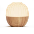 Wood-and-white essential oil diffuser with ribbed dome lid and logo on base