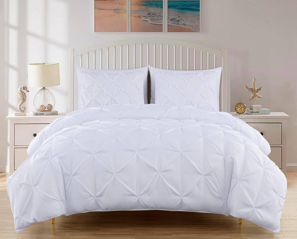 White king comforter set with quilted pinch pleat pattern and two pillow shams in front