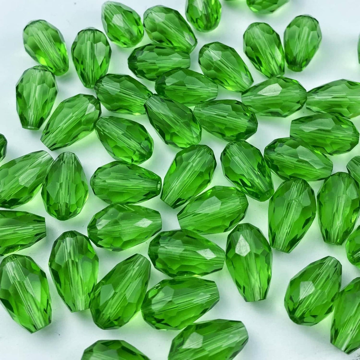 Assorted green faceted teardrop glass beads with vertical hole