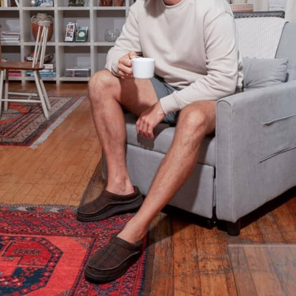 Mens dark brown clog slippers worn with casual outfit, slip-on style