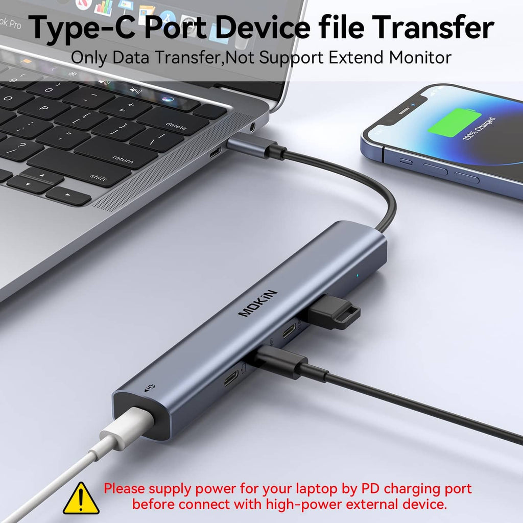USB-C hub connected to a laptop and a smartphone using multiple cables