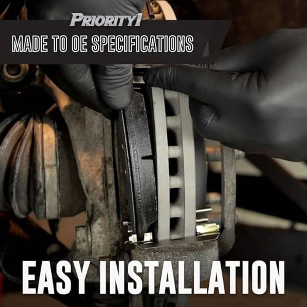 Rear brake pad installation with gloved hands holding a disc brake caliper