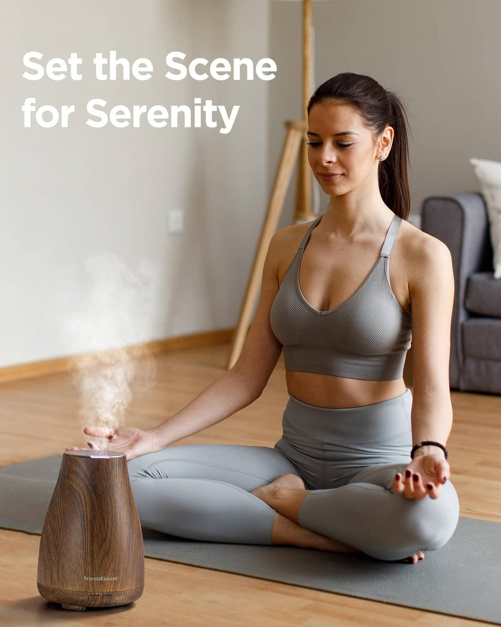 Bronze wood-grain essential oil diffuser producing a light mist cloud from the top