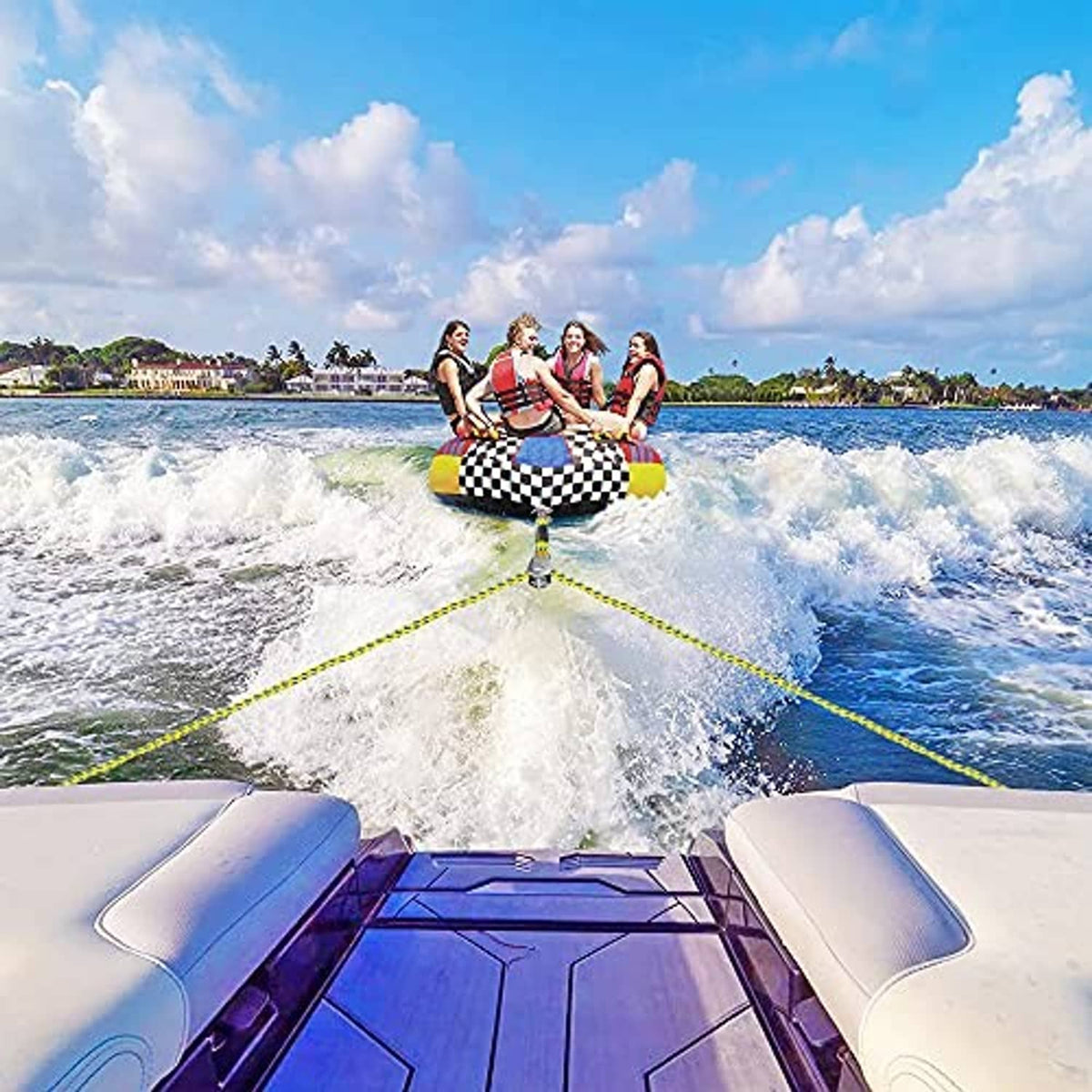 Yellow braided tow rope trailing behind a boat toward a rider on a wakeboard