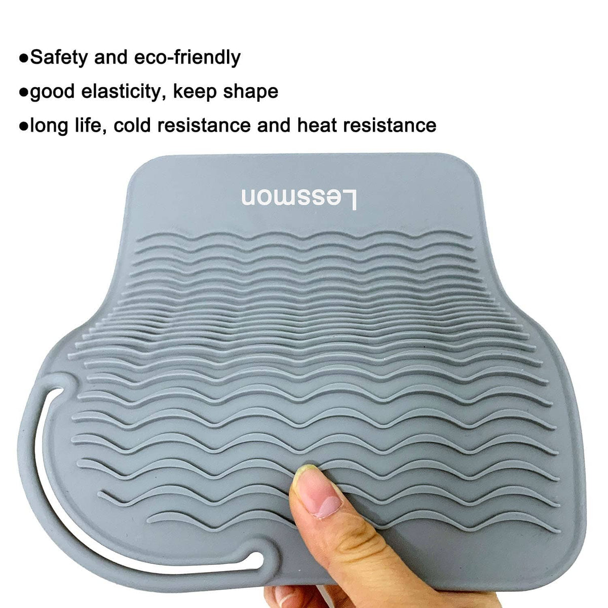Close-up of gray heat mat surface with wavy ridges and hand pressing center