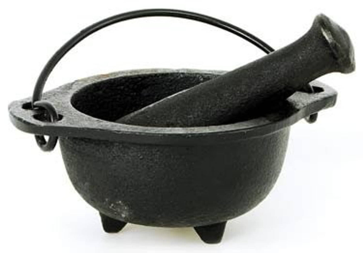Black cast iron cauldron mortar with pestle, side view