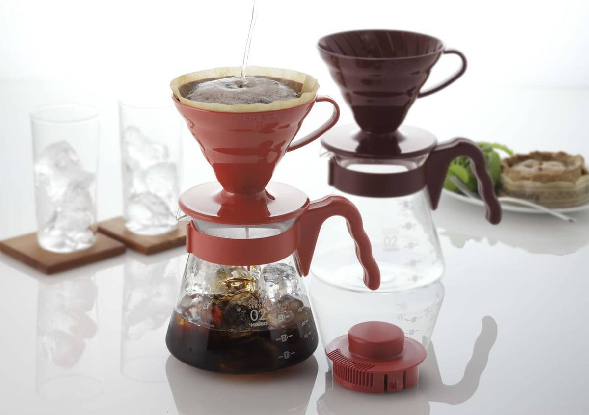 Red pour-over dripper set with carafe, filters, and red cap
