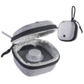 Grey hard-shell travel pouch with zipper and carabiner, opened to reveal ring holder