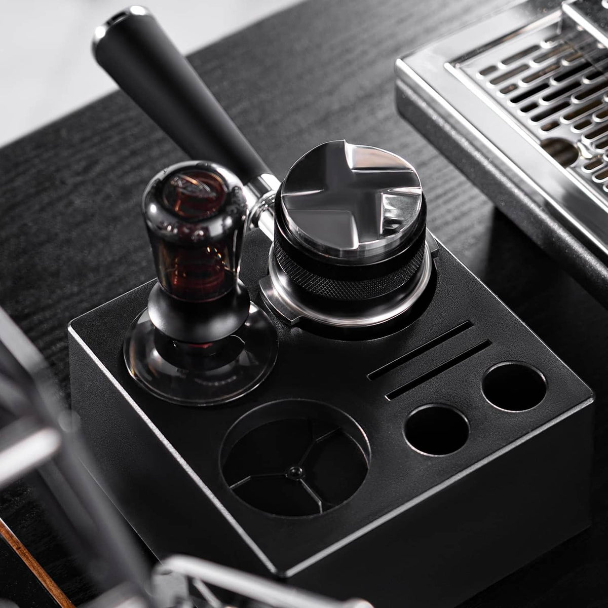 Black espresso tamper station base with fitted tamper and distributor tools
