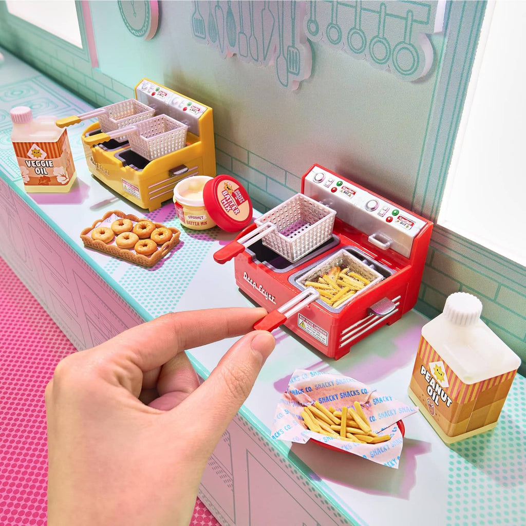 Mini kitchen appliance playset with red fryer machine, trays, and snack food pieces