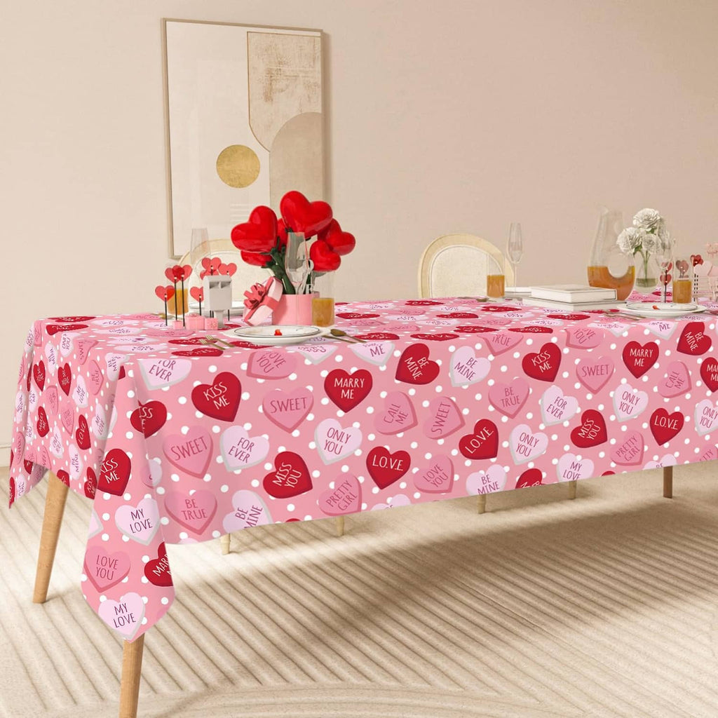 Pink Valentine tablecloth draped over a dining table with red and pink heart pattern