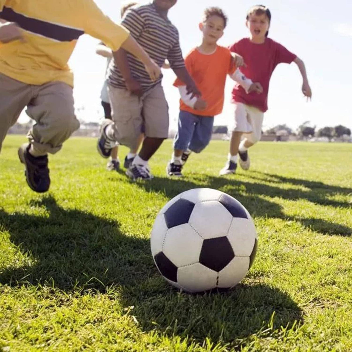 White and black soccer ball on the ground during play