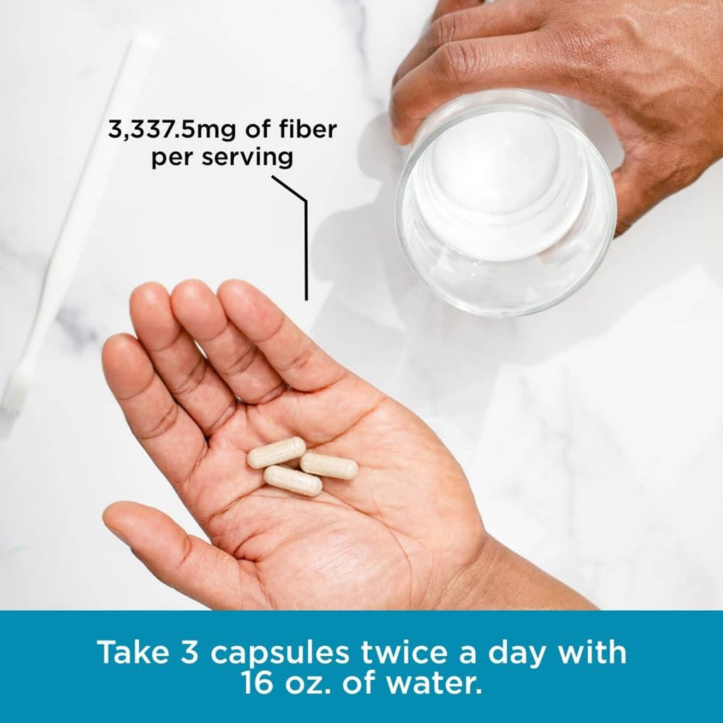 Psyllium fiber supplement capsules in hand with stay ready bottle, 3,337.5 mg per serving