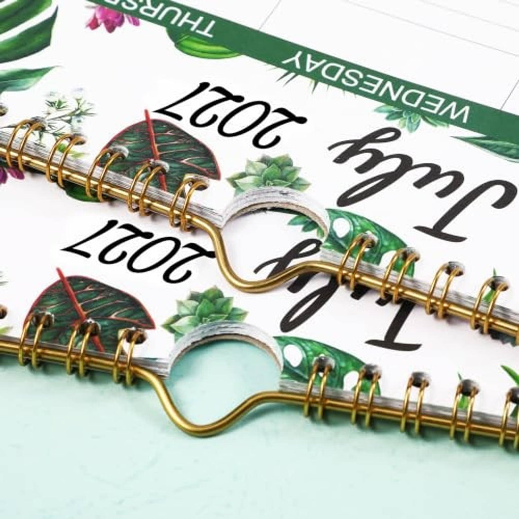 Spiral-bound wall calendar pages with 2027 month dates visible along the binder rings