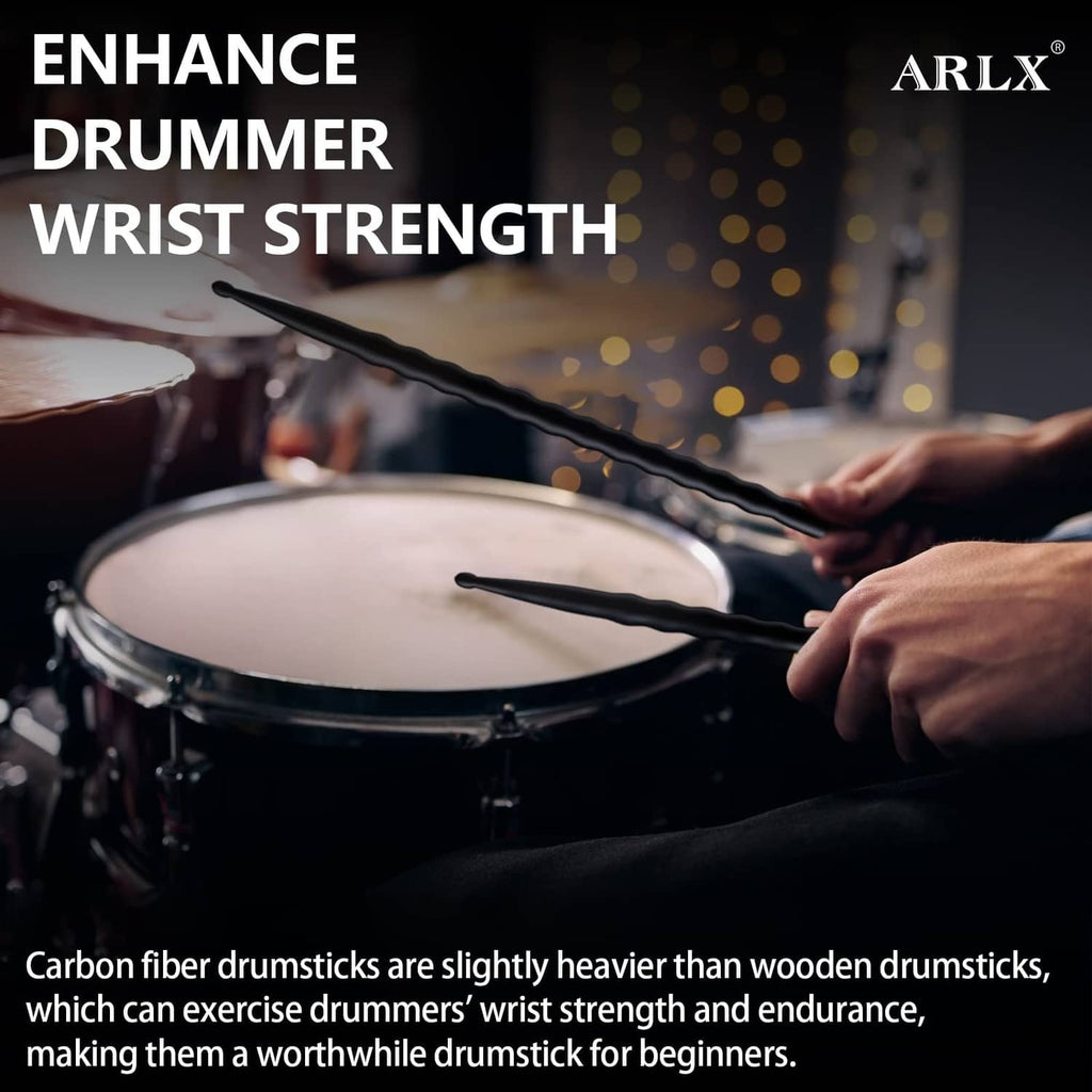 Black carbon fiber drumsticks held above a drum for playing