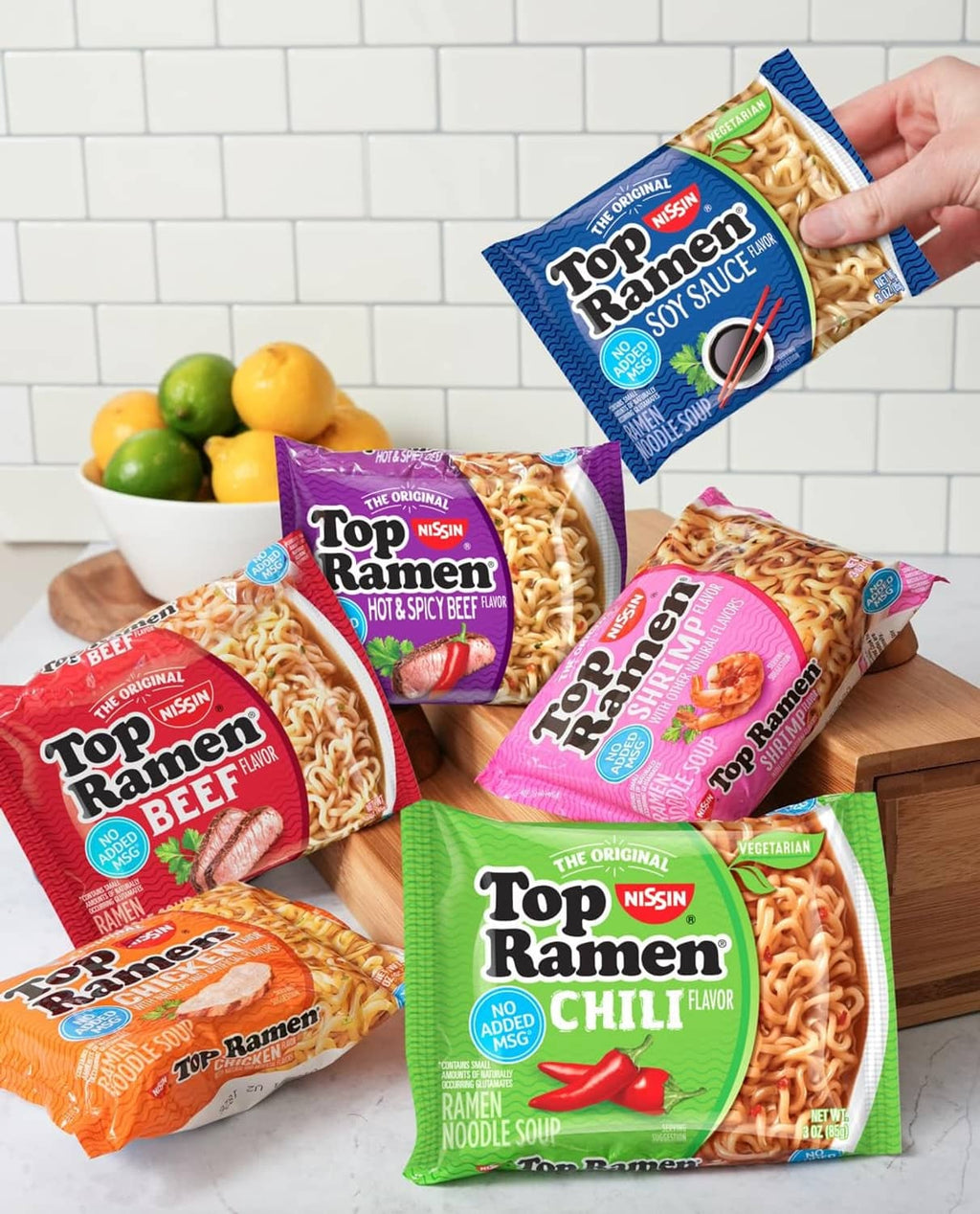 Assorted Top Ramen noodle soup packets, including Chili flavor, on a table