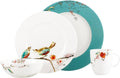 White bird-and-floral ceramic place setting with plates, bowl, and mug, teal accents
