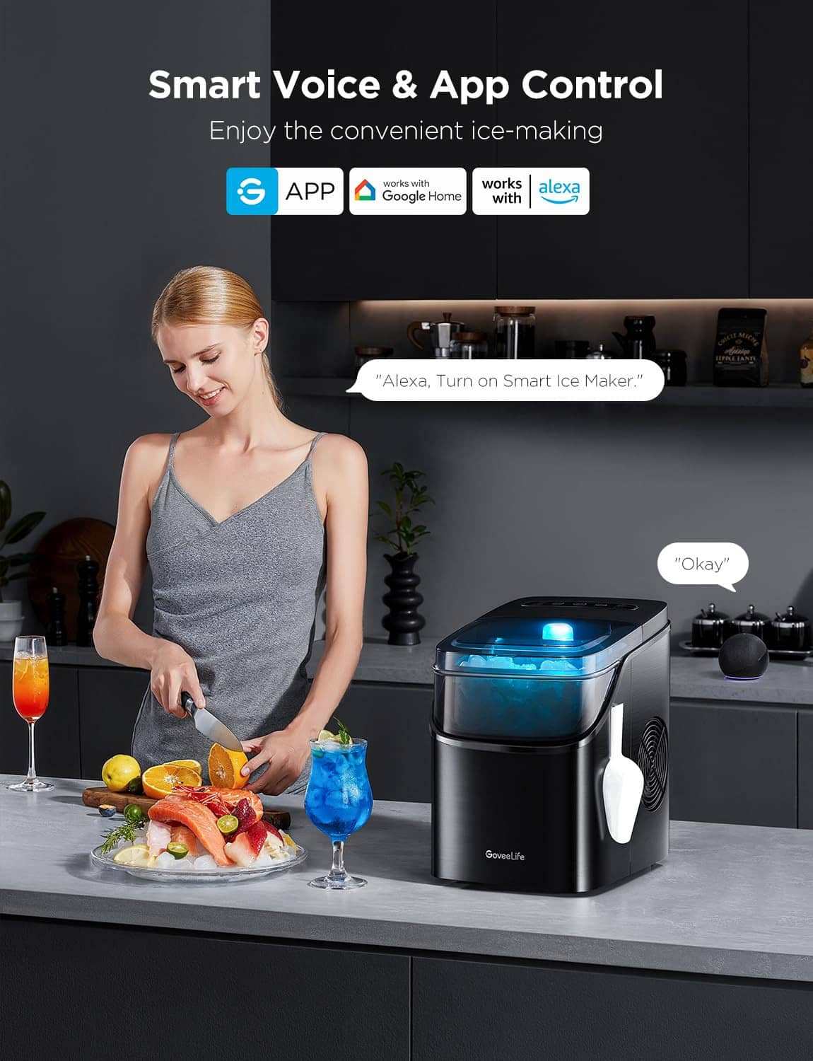 Portable ice maker on countertop with blue-lit window and ice scoop, voice control app visible