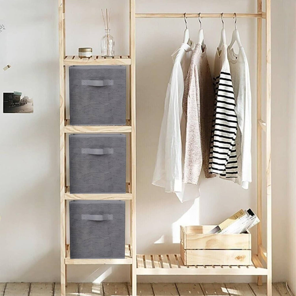 Foldable dark gray fabric storage bins with black stripe, stacked on a rack