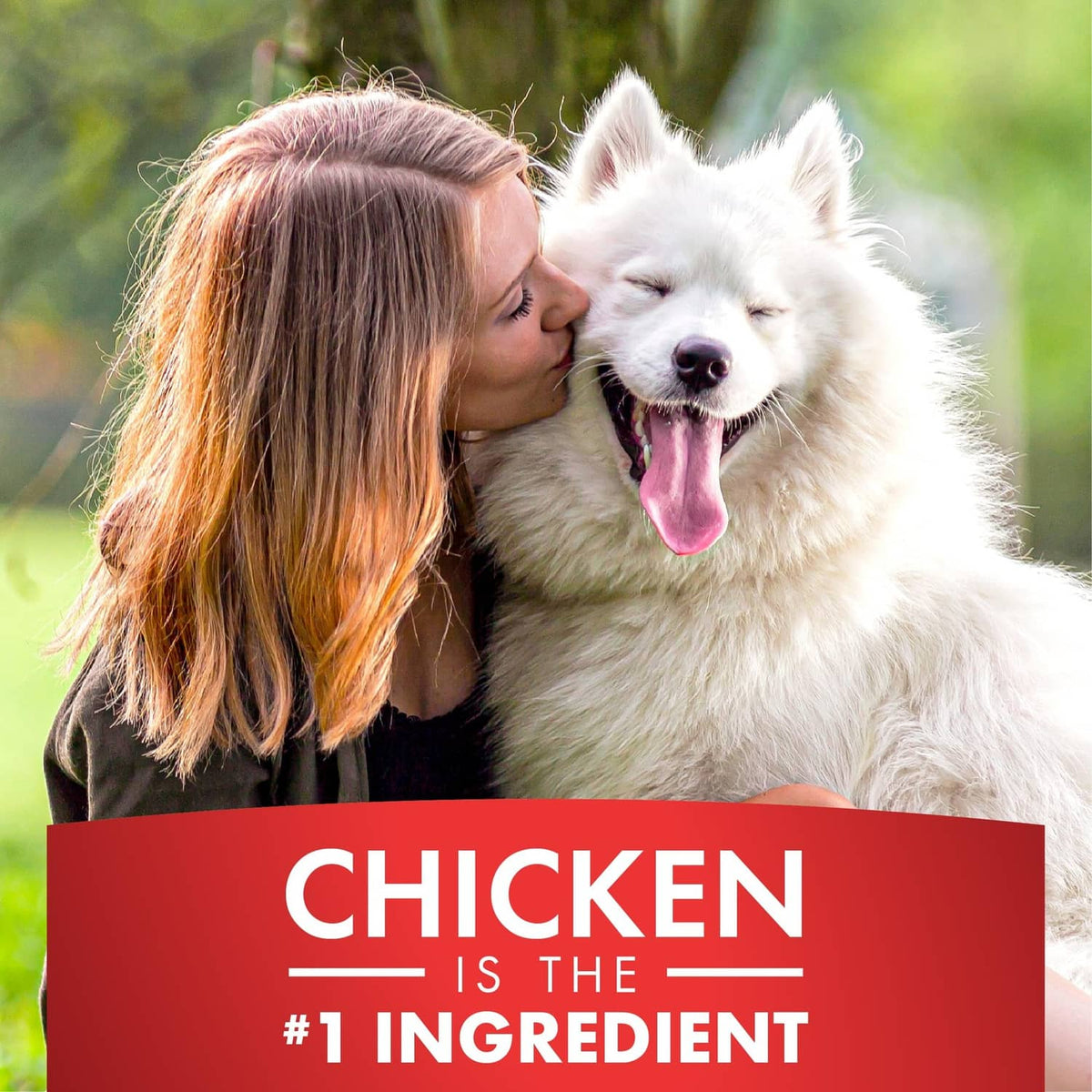 Dog and person kissing with label 'CHICKEN is the #1 ingredient'
