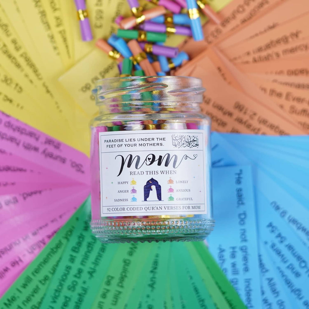 Close-up of Quran verses jar label with dark lid and colorful capsule rolls