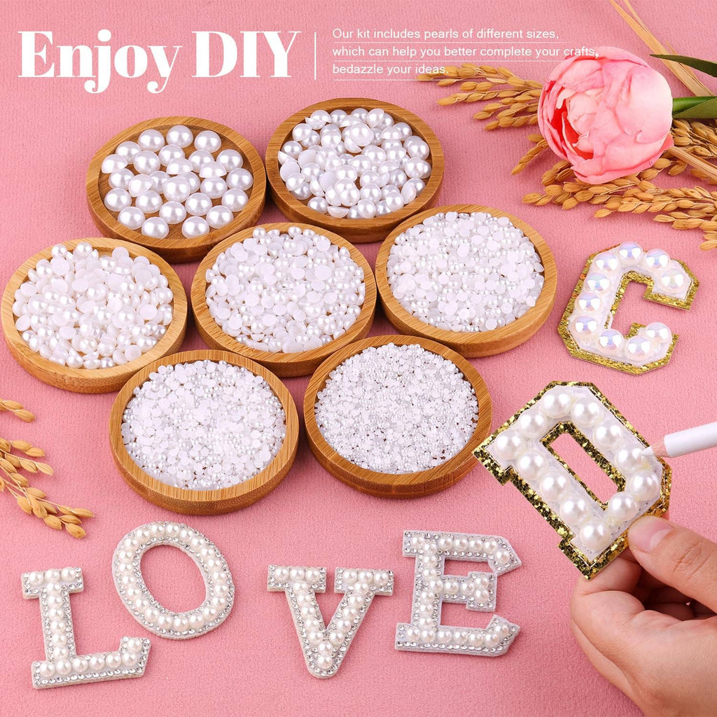 White flatback pearls in small round bowls for DIY crafts, with bead-letter decorations