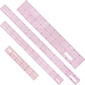 Clear plastic grid ruler set with red measurement markings, four pieces laid out