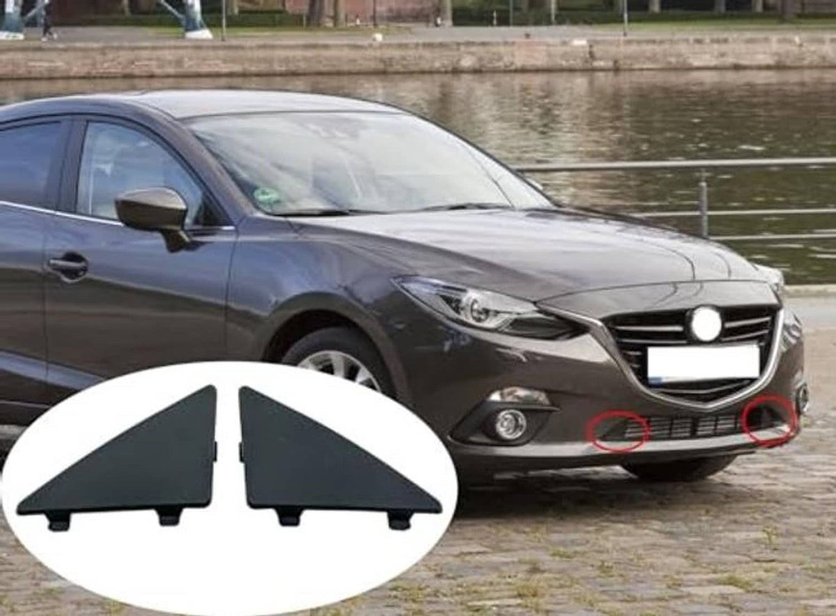 Triangular dark front bumper lower grille filler inserts shown for front bumper opening
