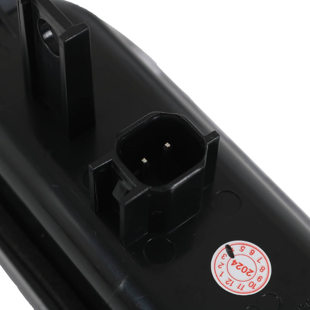 Close-up of black LED bed light connector port and circular label on housing