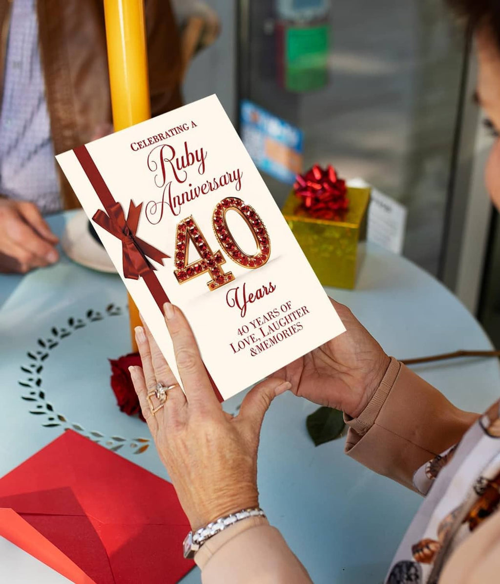 Ruby wedding anniversary card with red bow and 40 Years text held by two hands